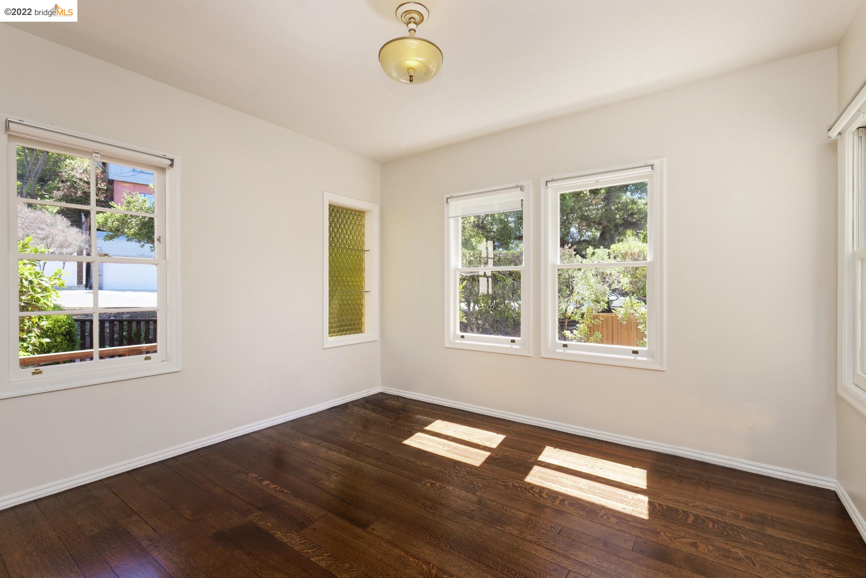 920 Spruce Street Berkeley, CA 94707 - Photo 16 of 36 a view of empty room with wooden floor and fan