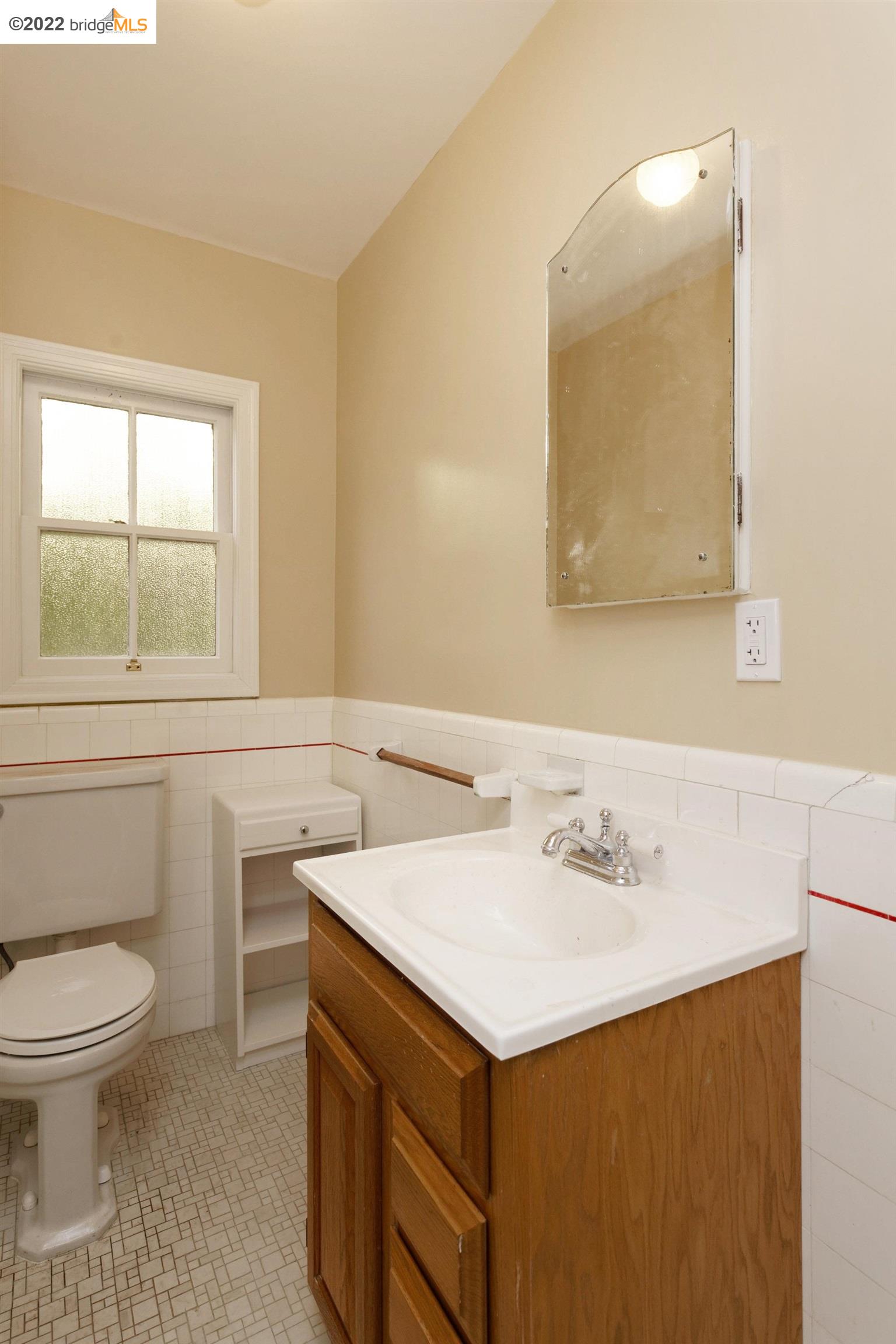 920 Spruce Street Berkeley, CA 94707 - Photo 17 of 36 a bathroom with a sink a toilet and a mirror