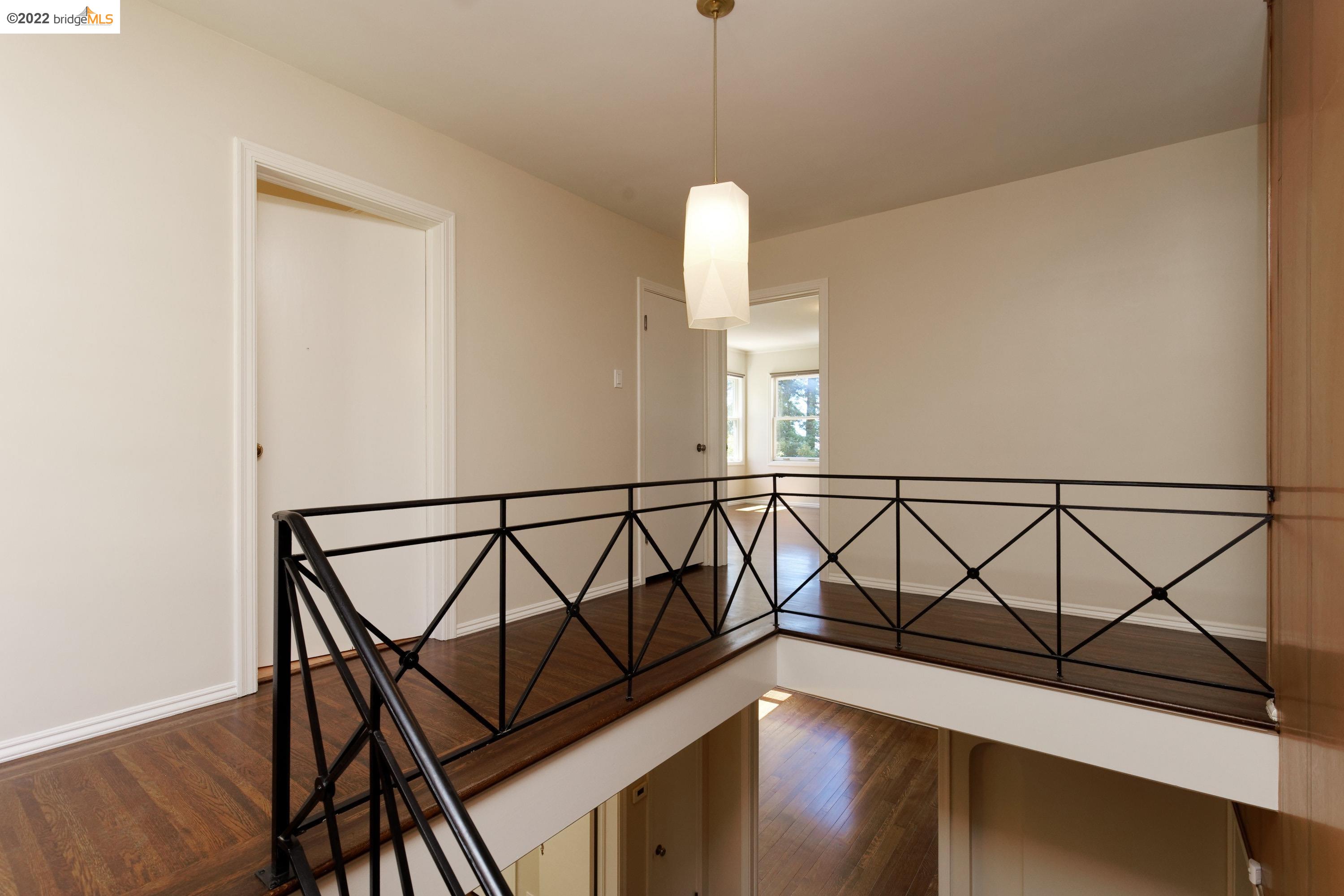 920 Spruce Street Berkeley, CA 94707 - Photo 19 of 36 a view of a hallway with wooden floor and staircase