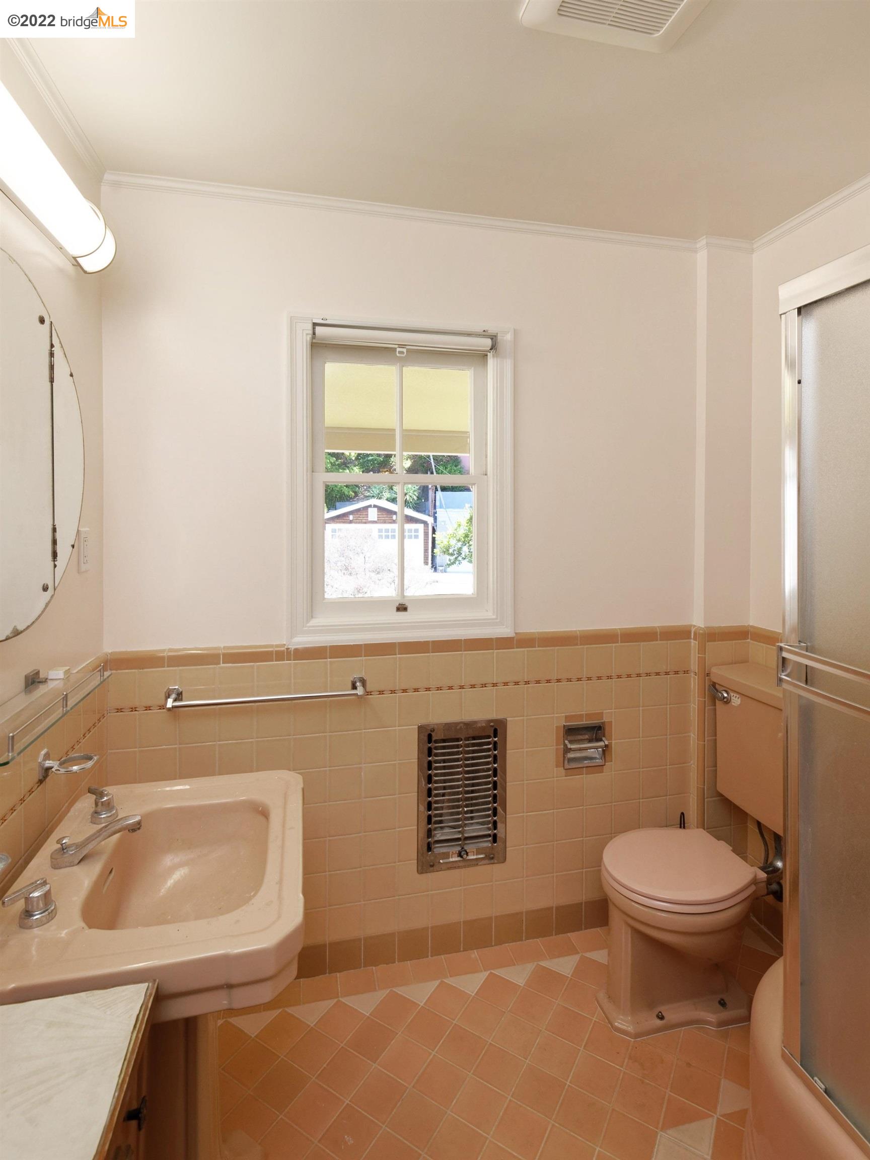 920 Spruce Street Berkeley, CA 94707 - Photo 22 of 36 a bathroom with a sink toilet and window