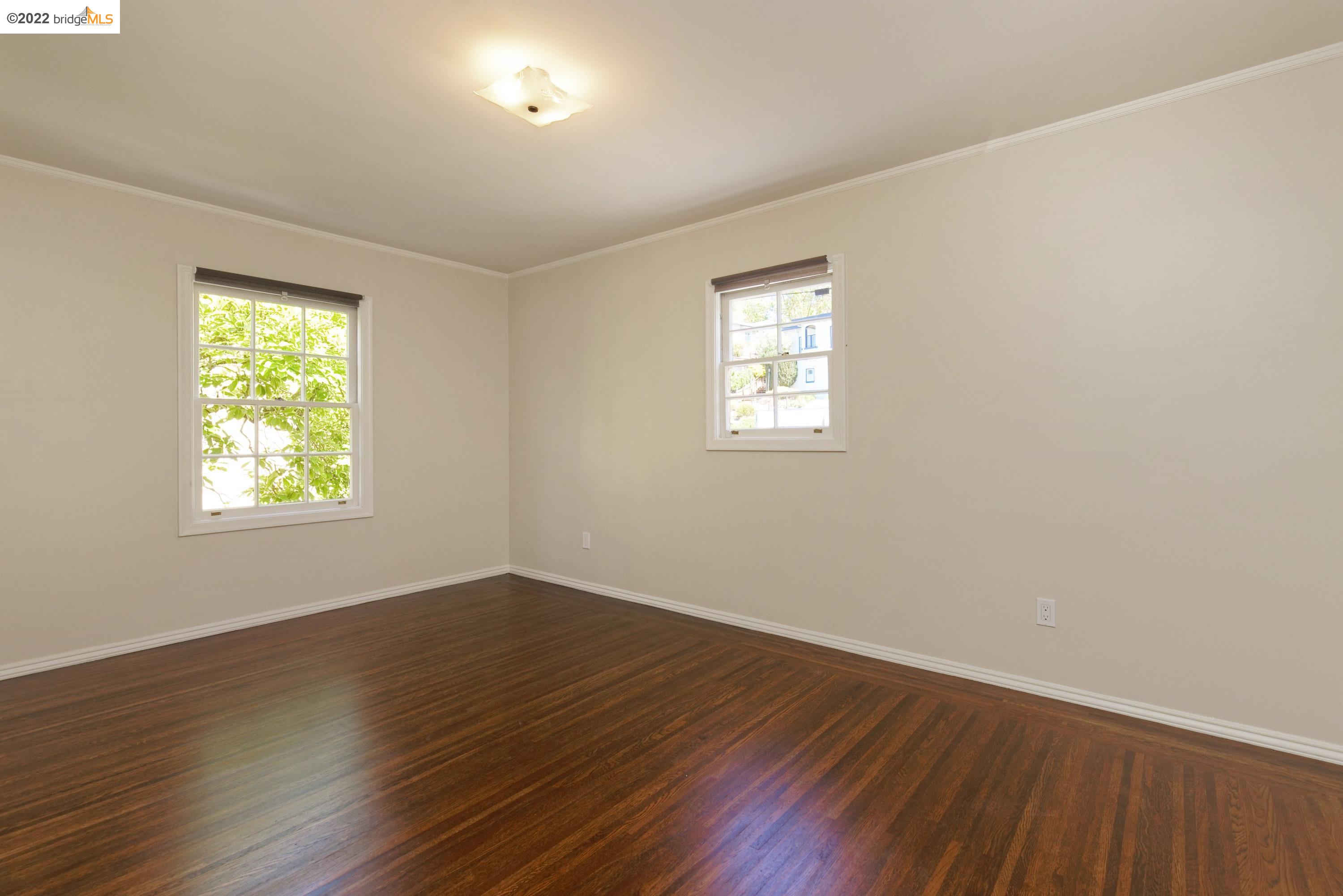 920 Spruce Street Berkeley, CA 94707 - Photo 29 of 36 a view of an empty room with wooden floor and a window