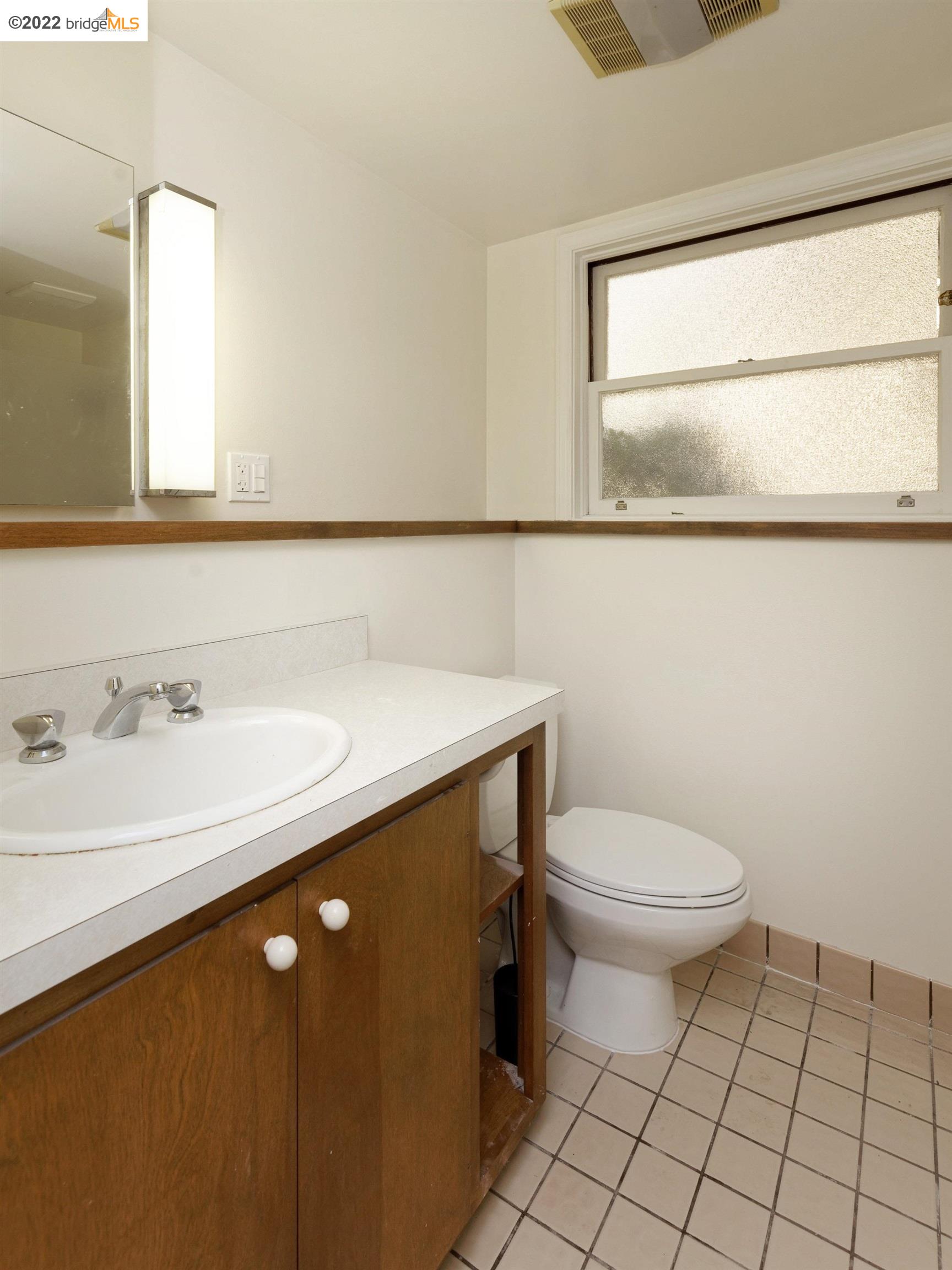 920 Spruce Street Berkeley, CA 94707 - Photo 32 of 36 a bathroom with a sink a toilet and mirror