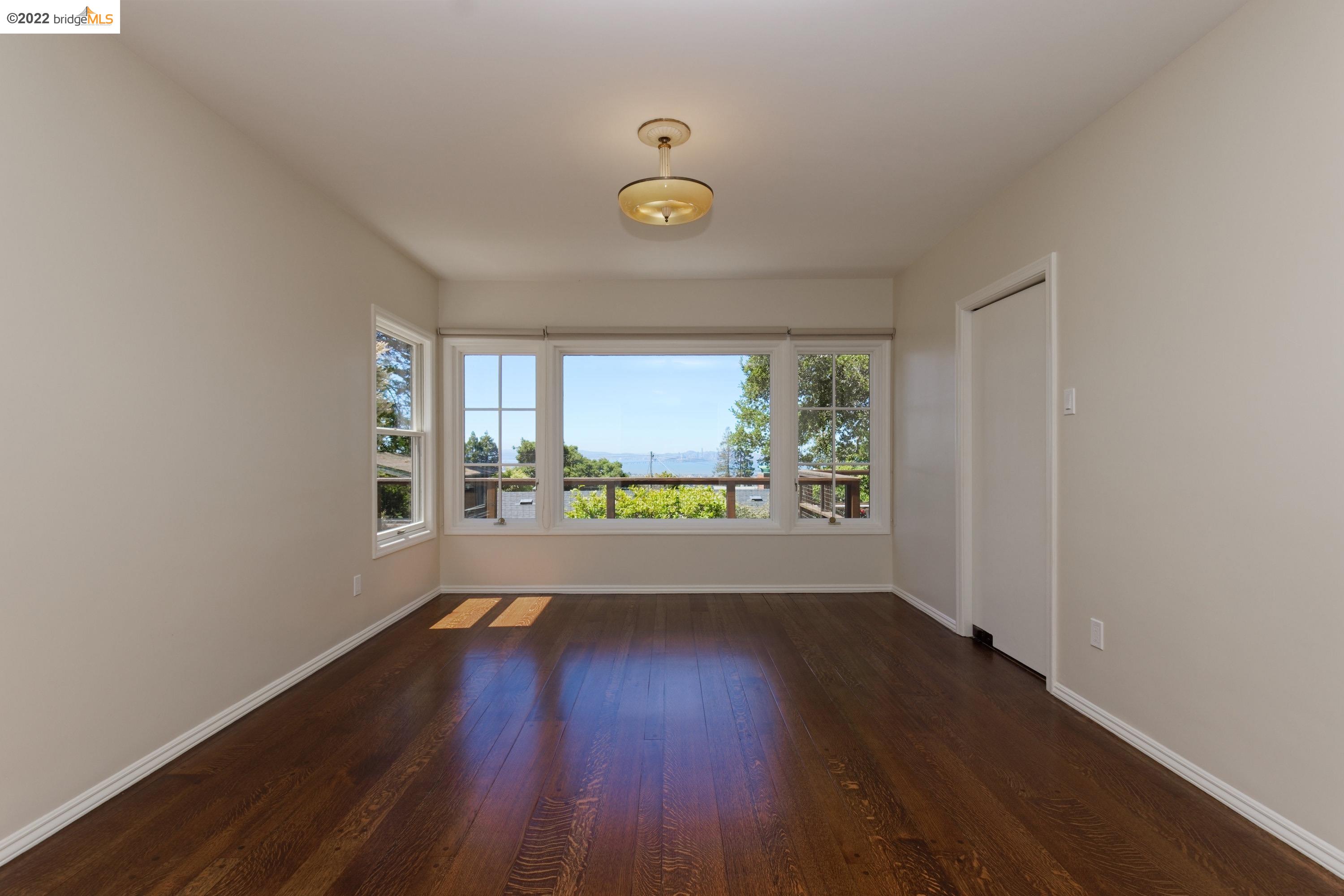 920 Spruce Street Berkeley, CA 94707 - Photo 10 of 36 a view of room with window and wooden floor