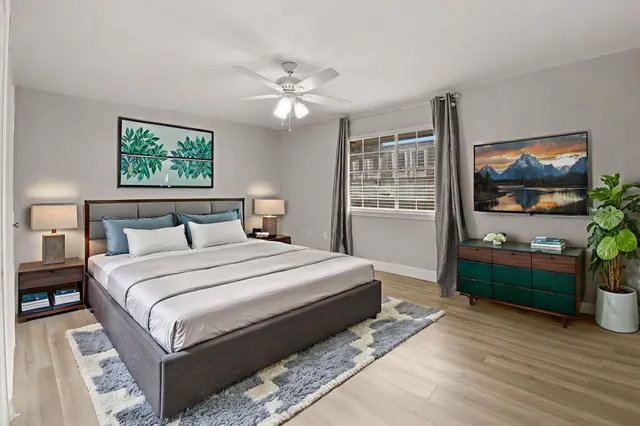 a bedroom with a bed and a flat screen tv