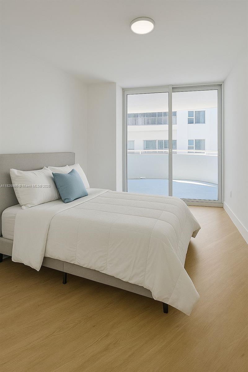 6301 Collins Avenue, Unit 1005 Miami Beach, FL 33141 - Photo 11 of 35 a bedroom with a bed and a window