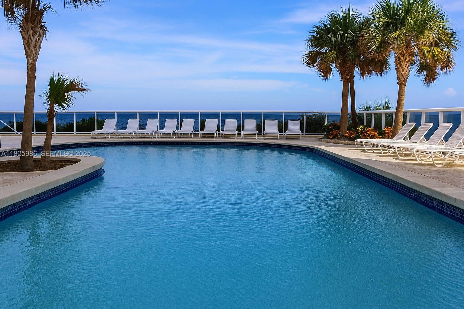 6301 Collins Avenue, Unit 1005 Miami Beach, FL 33141 - Photo 18 of 35 a view of swimming pool with outdoor seating and a garden
