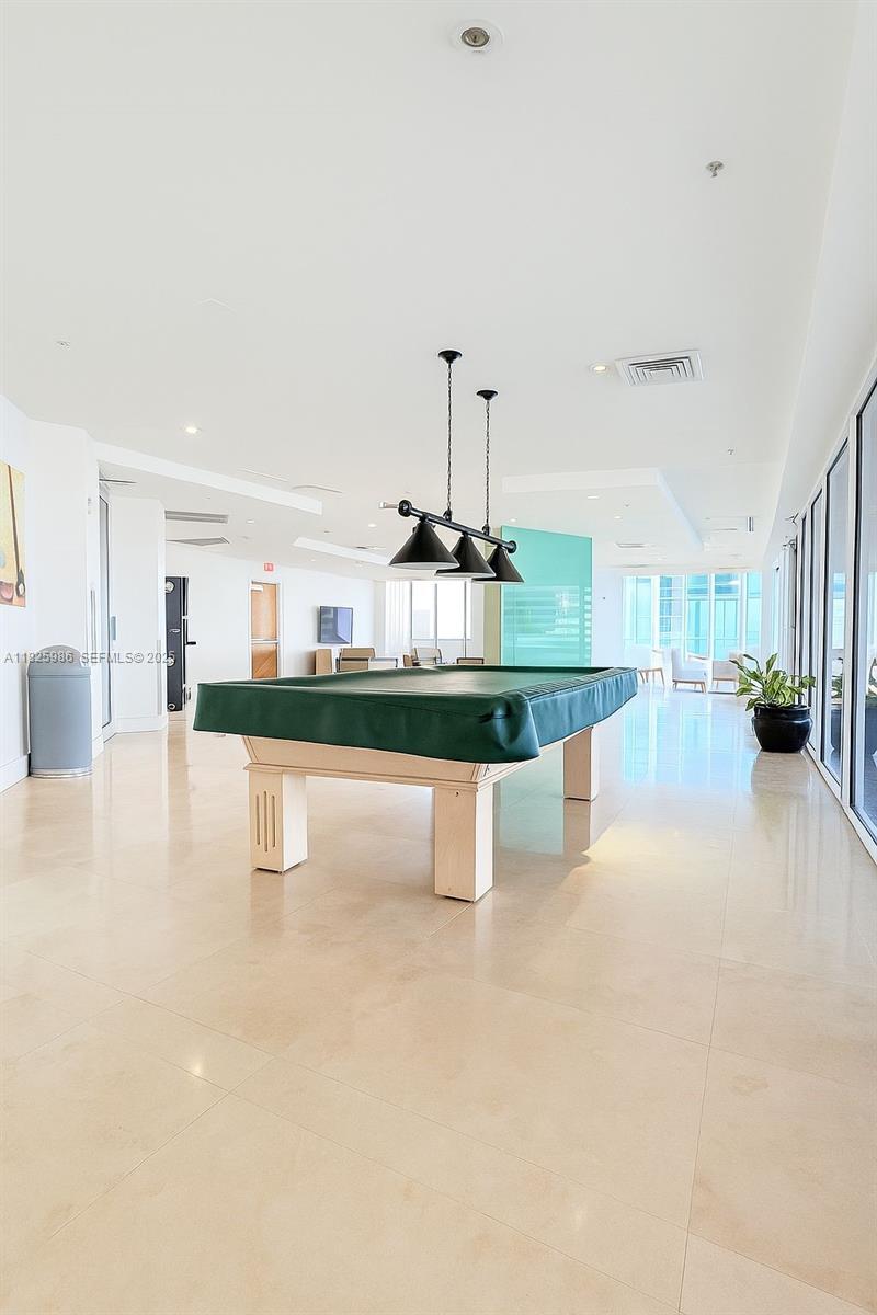 6301 Collins Avenue, Unit 1005 Miami Beach, FL 33141 - Photo 20 of 35 a dining hall with stainless steel appliances kitchen island granite countertop a living room view