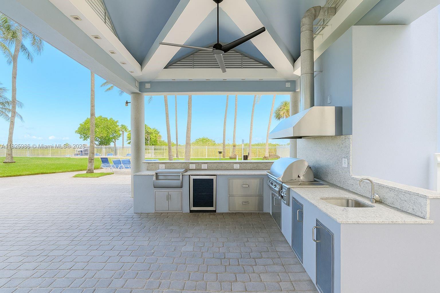 6301 Collins Avenue, Unit 1005 Miami Beach, FL 33141 - Photo 23 of 35 a kitchen with a sink and a stove top oven