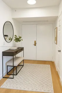 a view of a room with wooden floor and a potted plant