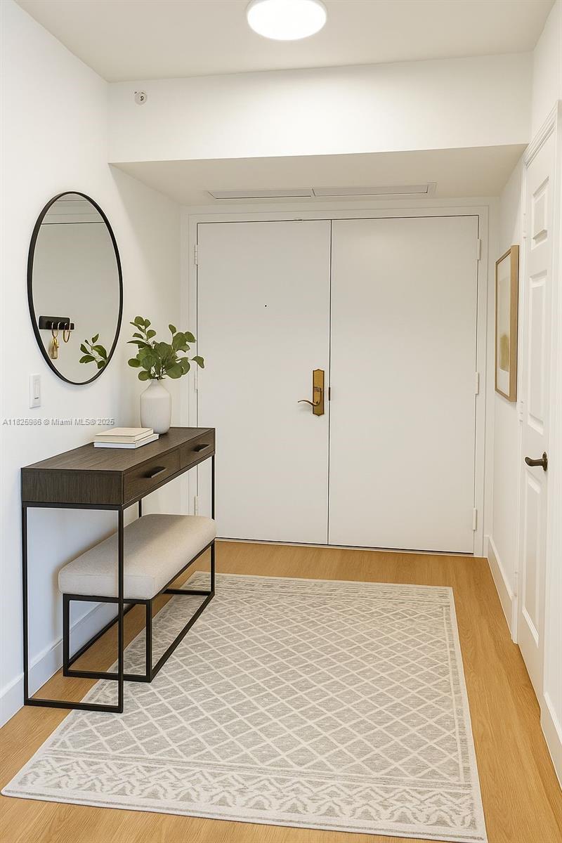 6301 Collins Avenue, Unit 1005 Miami Beach, FL 33141 - Photo 3 of 35 a view of a room with wooden floor and a potted plant
