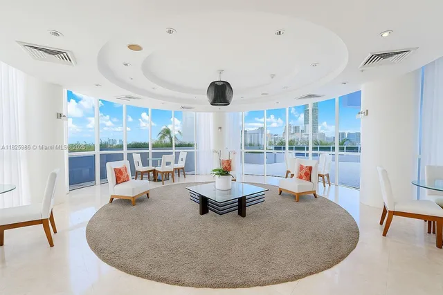 a living room with large window and furniture