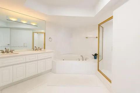 a spacious bathroom with a bathtub sink and mirror