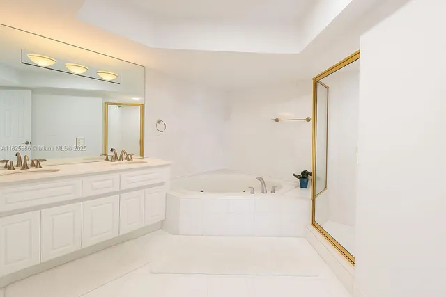 a spacious bathroom with a bathtub sink and mirror