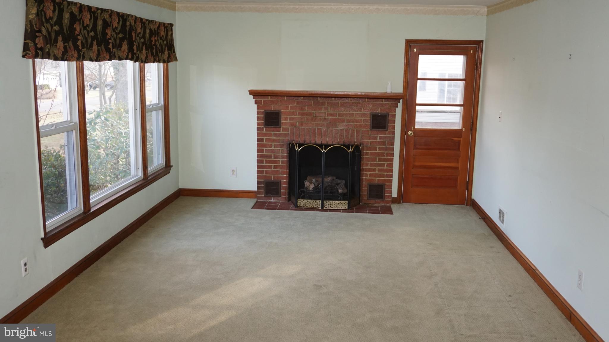 45927 Rolling Road Lexington Park, MD 20653 - Photo 11 of 31 a view of empty room with fireplace and window