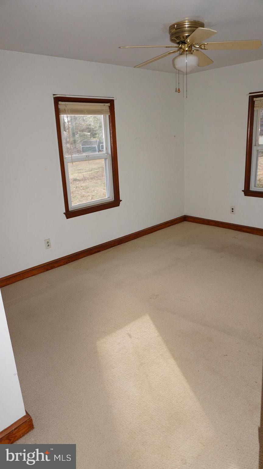 45927 Rolling Road Lexington Park, MD 20653 - Photo 16 of 31 an empty room with a ceiling fan and wooden floor
