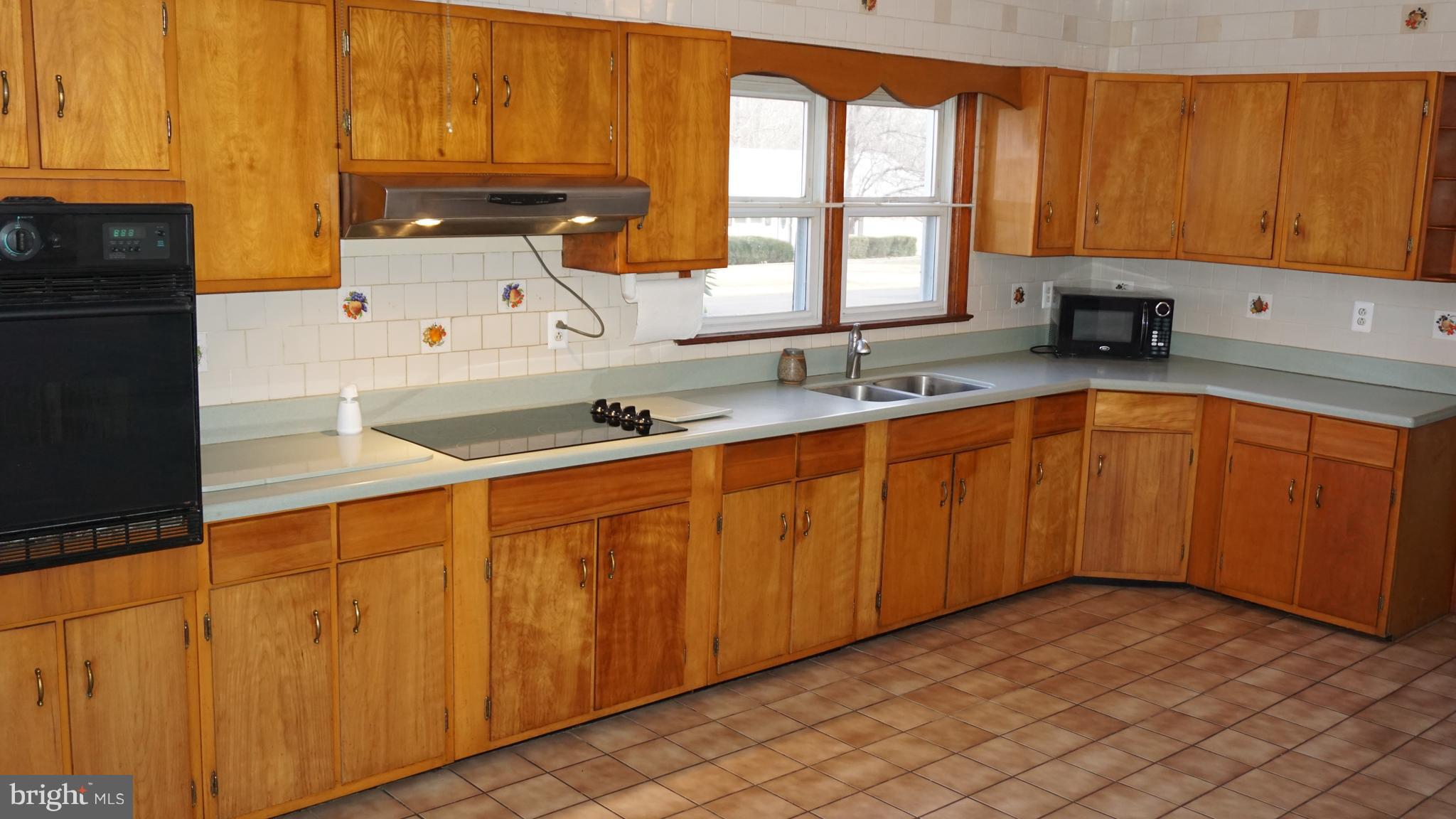 45927 Rolling Road Lexington Park, MD 20653 - Photo 5 of 31 a kitchen with stainless steel appliances a sink cabinets and a window