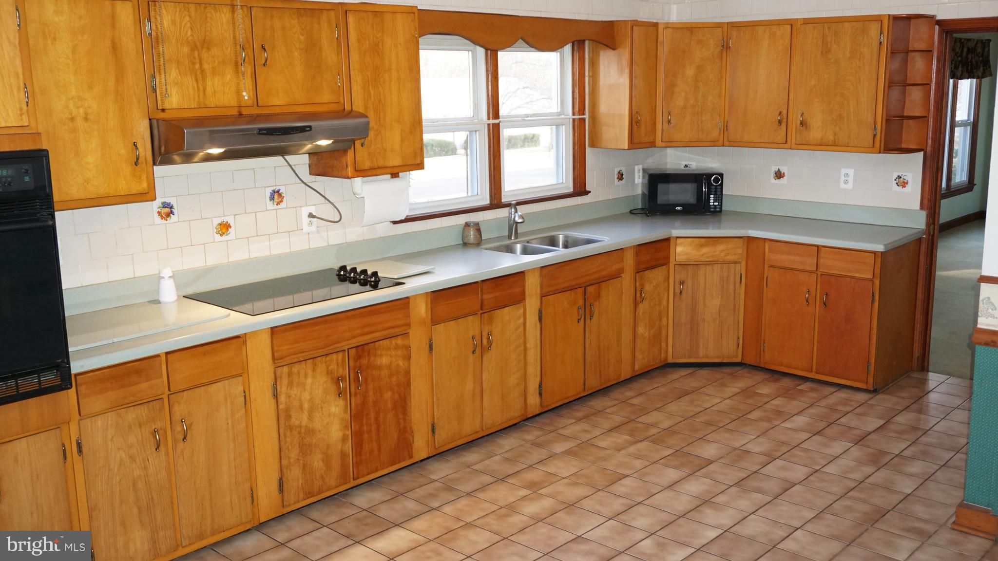 45927 Rolling Road Lexington Park, MD 20653 - Photo 6 of 31 a kitchen with stainless steel appliances a sink window and cabinets