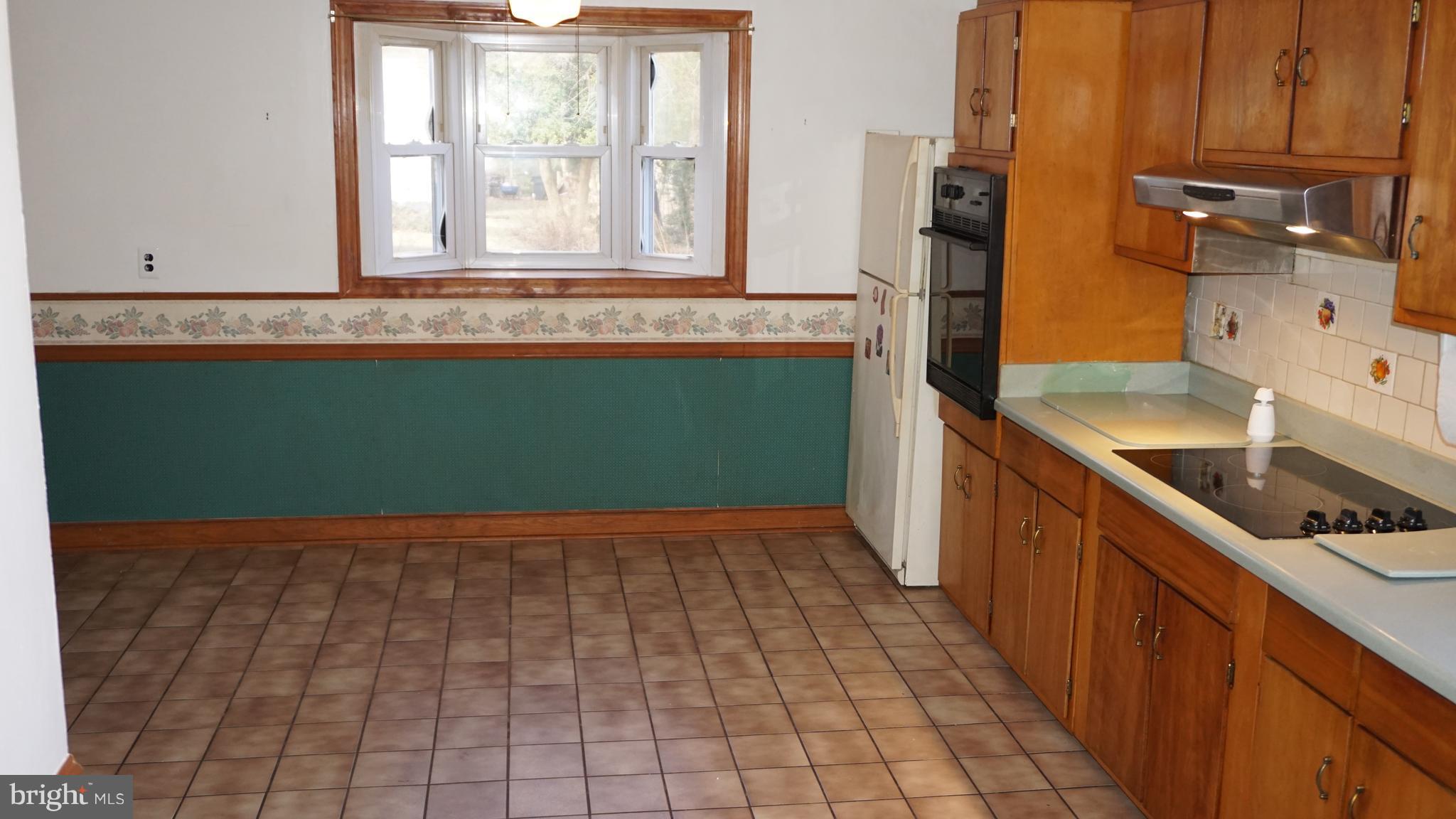 45927 Rolling Road Lexington Park, MD 20653 - Photo 7 of 31 a kitchen with a sink window and cabinets