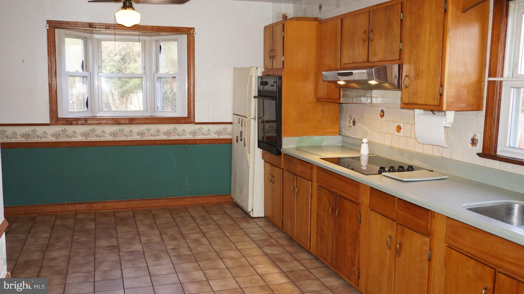 45927 Rolling Road Lexington Park, MD 20653 - Photo 9 of 31 a kitchen with a sink cabinets and window