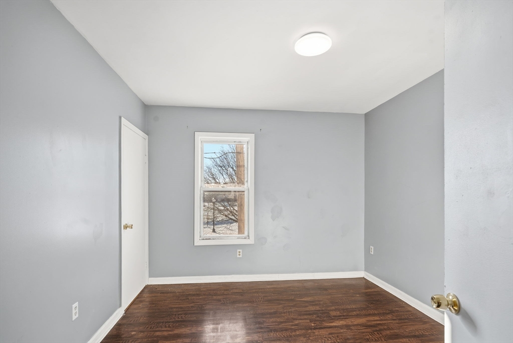 391 Rivet Street, Unit 2 New Bedford, MA 02744 - Photo 12 of 13 an empty room with wooden floor and windows