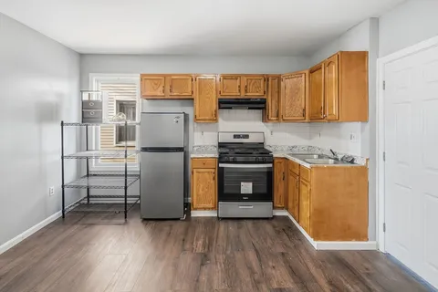 a kitchen with stainless steel appliances a refrigerator and a stove top oven