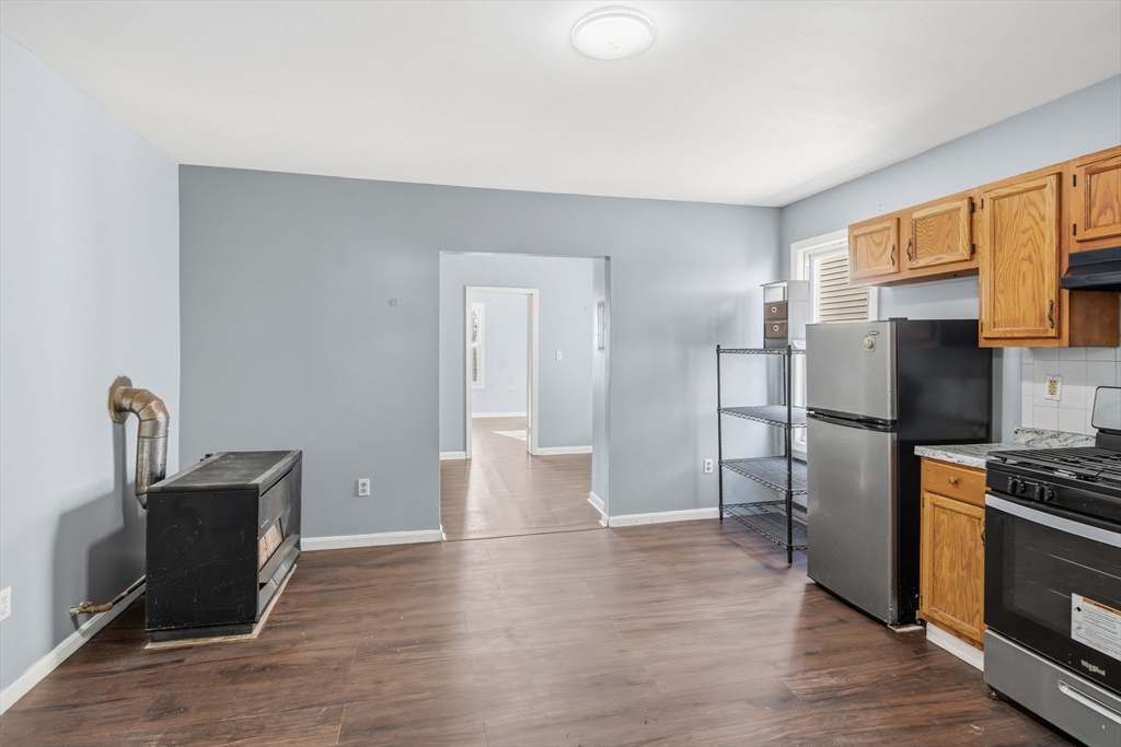 391 Rivet Street, Unit 2 New Bedford, MA 02744 - Photo 3 of 13 a kitchen with stainless steel appliances a refrigerator stove and sink
