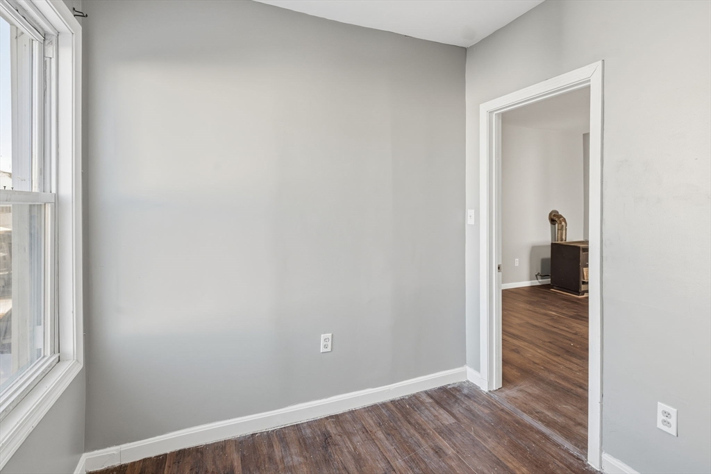 391 Rivet Street, Unit 2 New Bedford, MA 02744 - Photo 7 of 13 a view of a hallway with wooden floor and a room