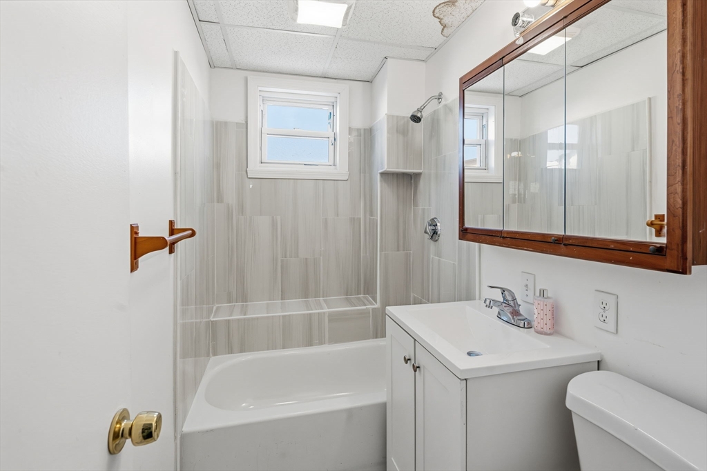 391 Rivet Street, Unit 2 New Bedford, MA 02744 - Photo 8 of 13 a bathroom with a sink a toilet and shower