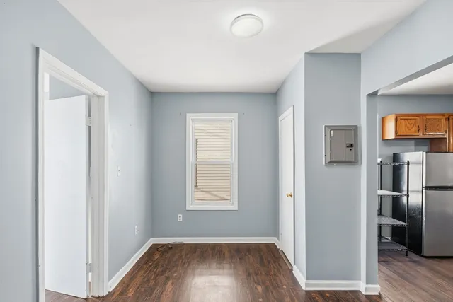 a view of hallway with wooden floor and stairs
