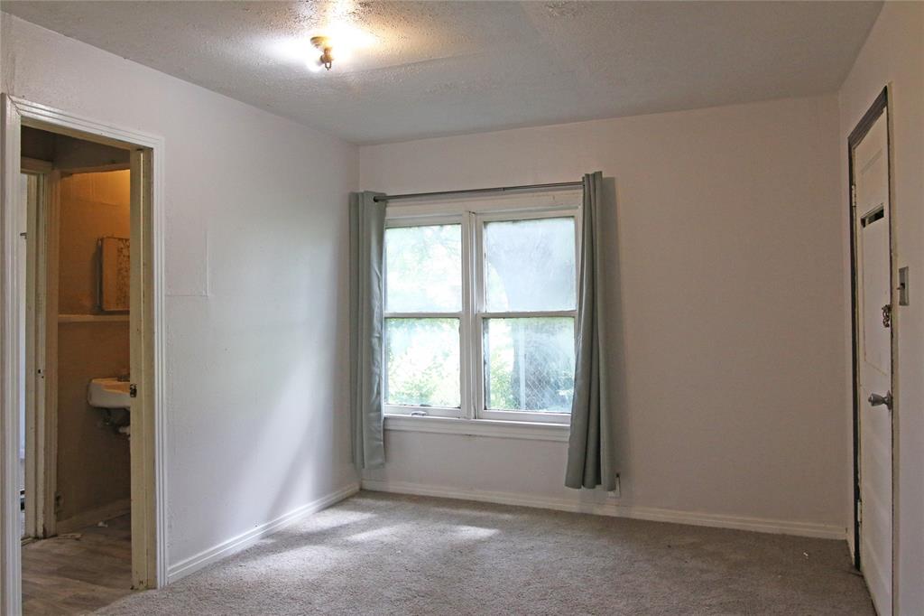1508 Witt Street Waco, TX 76704 - Photo 11 of 37 Unfurnished bedroom with carpet floors and a textured ceiling