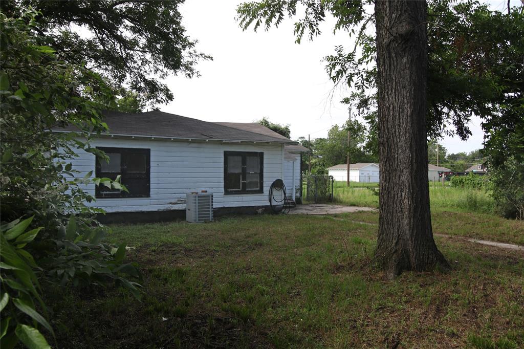 1508 Witt Street Waco, TX 76704 - Photo 30 of 37 Back of property featuring a lawn and a shingled roof