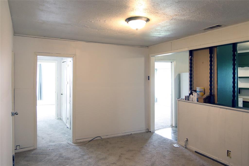 1508 Witt Street Waco, TX 76704 - Photo 8 of 37 Empty room featuring carpet floors and a textured ceiling