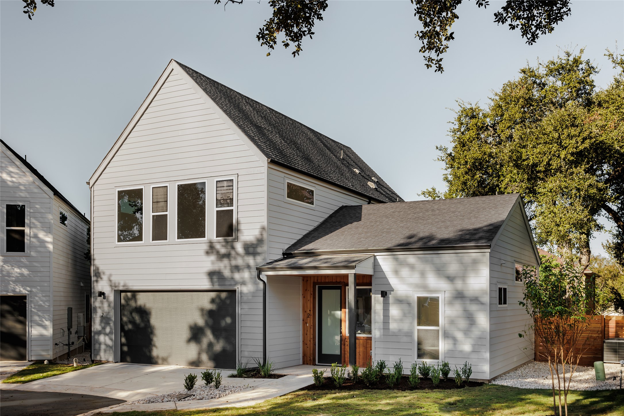 5107 Manchaca Road, Unit 2 Austin, TX 78745 - Photo 1 of 1 View of front of house with driveway, a garage, and fence