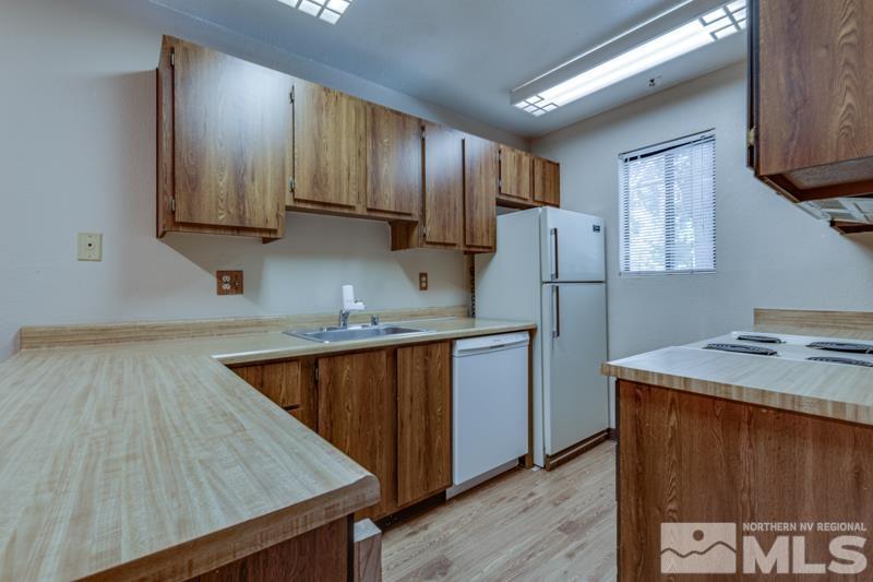 4428 Matich Drive Reno, NV 89502 - Photo 4 of 26 a kitchen with stainless steel appliances granite countertop refrigerator sink and cabinets