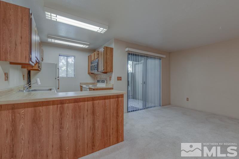 4428 Matich Drive Reno, NV 89502 - Photo 5 of 26 a bathroom with double vanity and a mirror