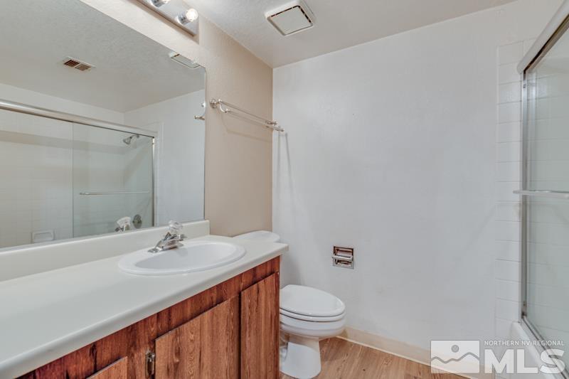 4428 Matich Drive Reno, NV 89502 - Photo 8 of 26 a bathroom with a sink vanity mirror and toilet