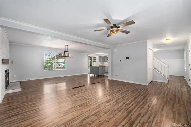 a living room with furniture a view and wooden floor