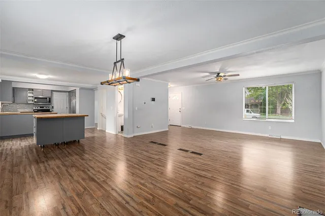 a view of an empty room with a window and fireplace