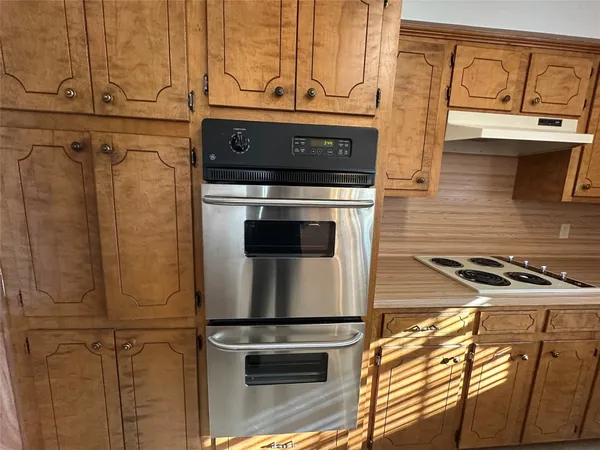 a stove top oven sitting inside of a kitchen
