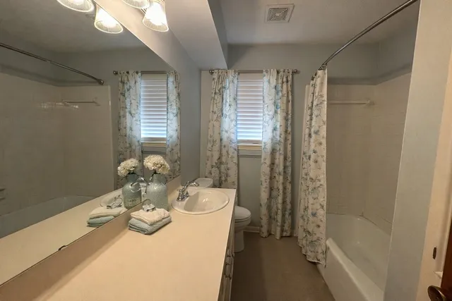 a bedroom with bed and a chandelier