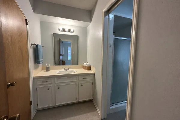 a bathroom with a double vanity sink and a mirror