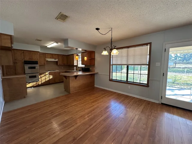 a kitchen with stainless steel appliances granite countertop a sink counter space cabinets and a window