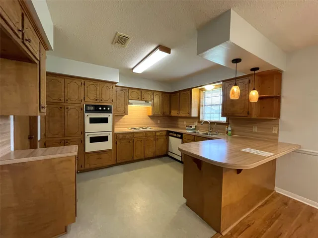 a stove top oven sitting inside of a kitchen
