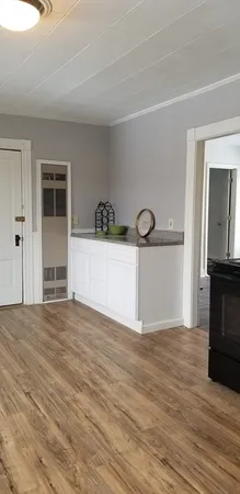 a view of a kitchen with a sink and a refrigerator