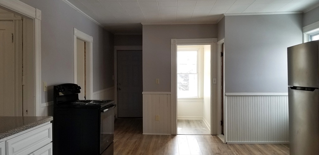 9 Pine Street, Unit 2 Dudley, MA 01571 - Photo 3 of 6 a view of a kitchen from the hallway