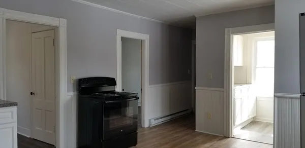 a kitchen with a refrigerator and a stove top oven