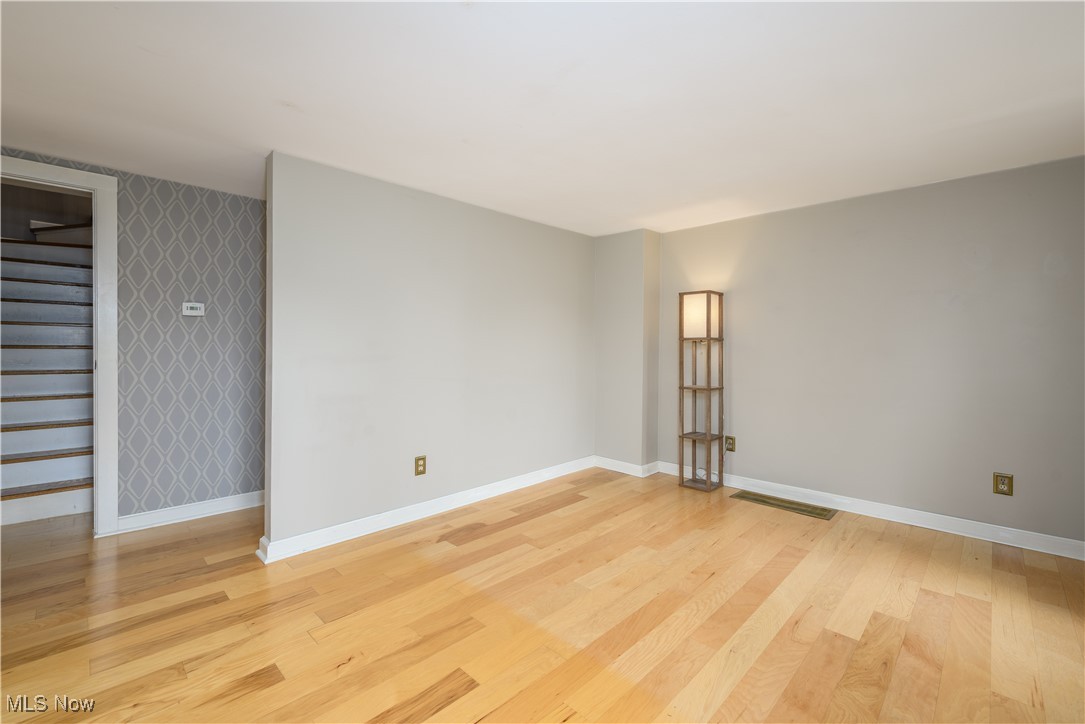 208 East Comet Road Clinton, OH 44216 - Photo 26 of 45 Living room with view to staircase and hallway to primary bedroom