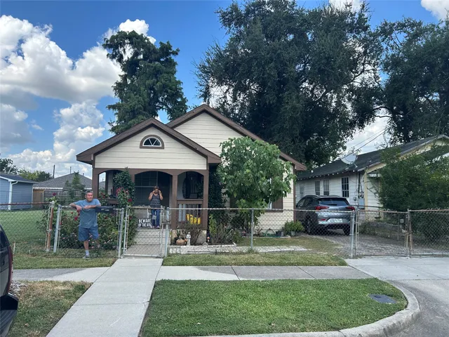 a front view of a house with sitting area and garden