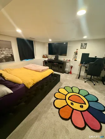a bedroom with a bed and a flat screen tv