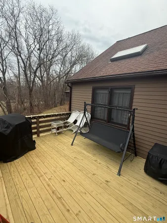 a living room with furniture a flat screen tv and a window